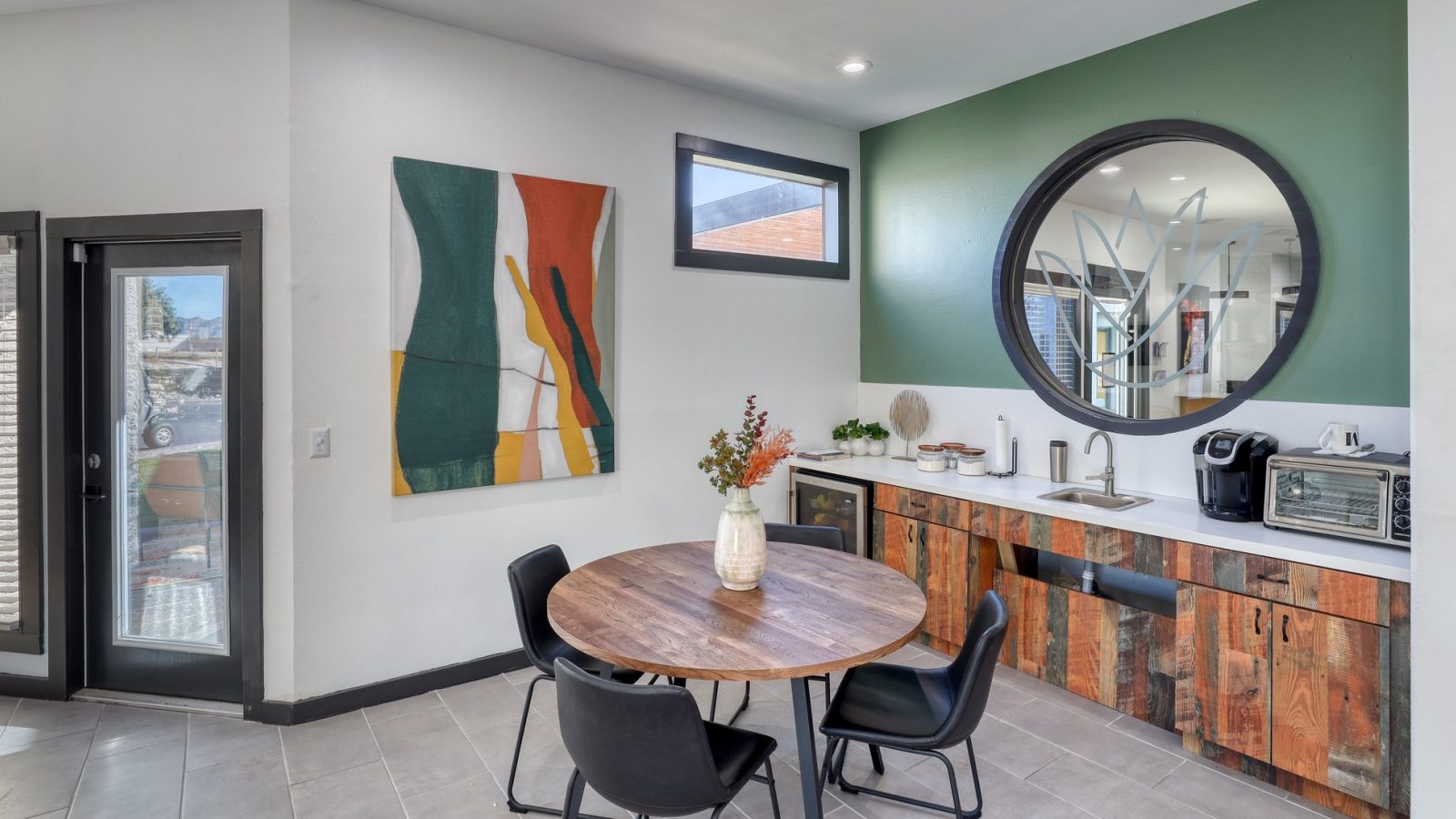 a kitchen with a table and chairs and a painting on the wall at The Jerome