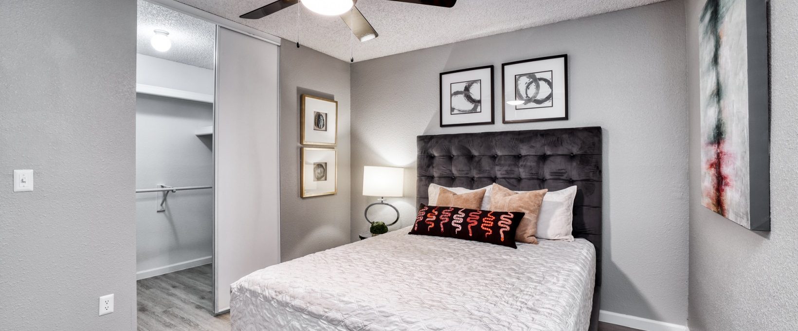 a bedroom with a ceiling fan and a bed at The Jerome