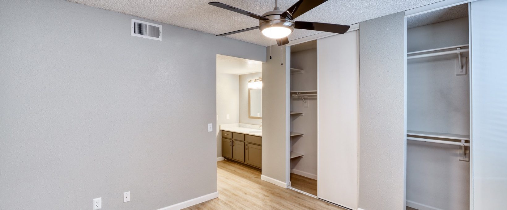 empty room with ceiling fan and closet at The Jerome