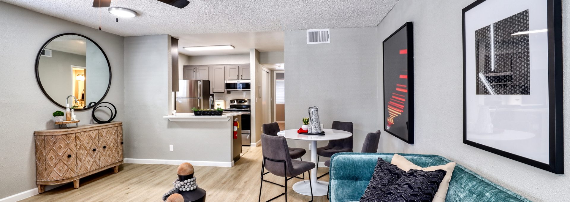 a living room with a ceiling fan and a couch at The Jerome